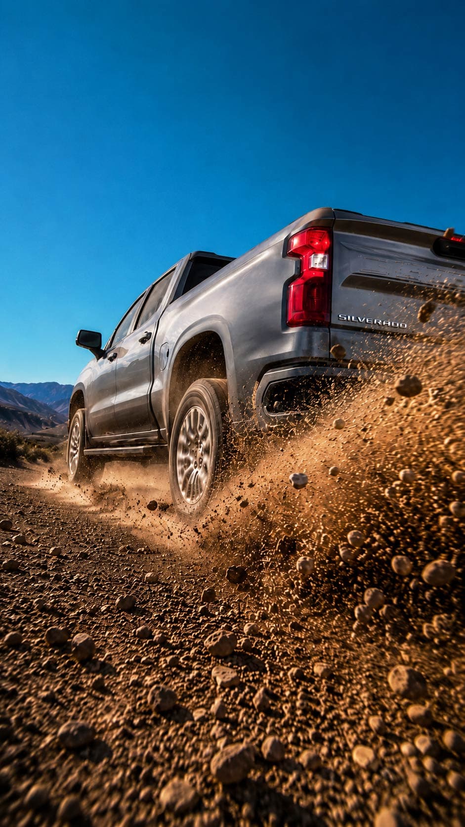 Chevrolet Silverado silver truck in dirt