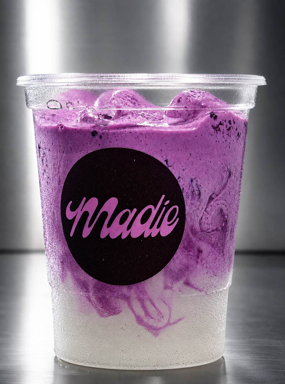 Iced specialty purple latte with Madie sticker
