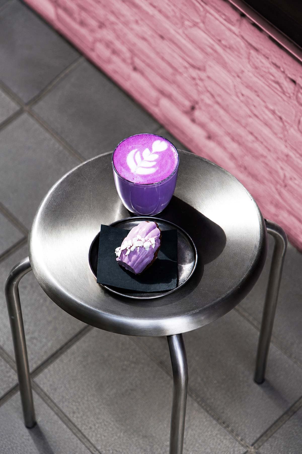 Specialty purple coffee beverage on metal stool