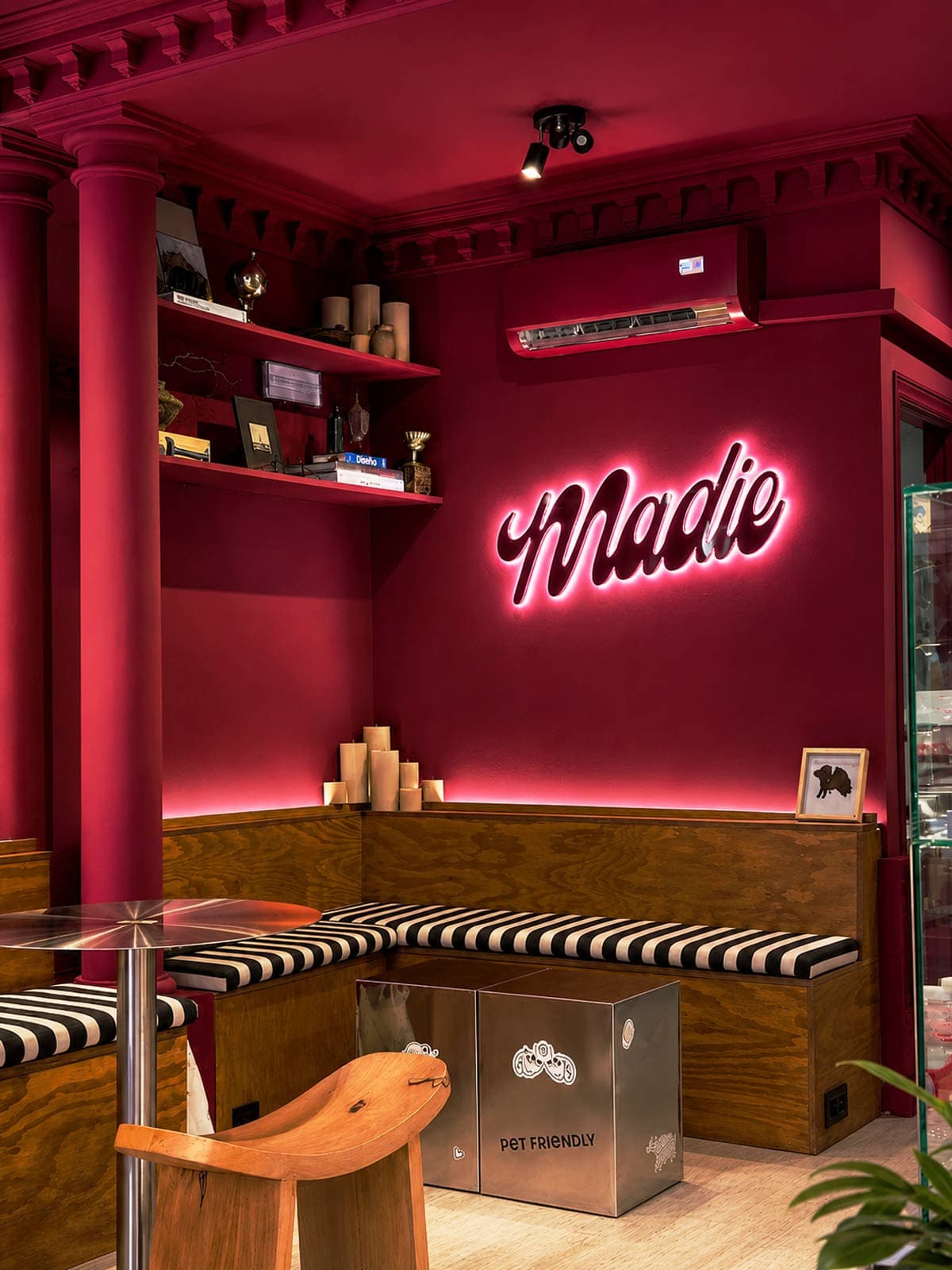Cozy interior booth seating with neon sign