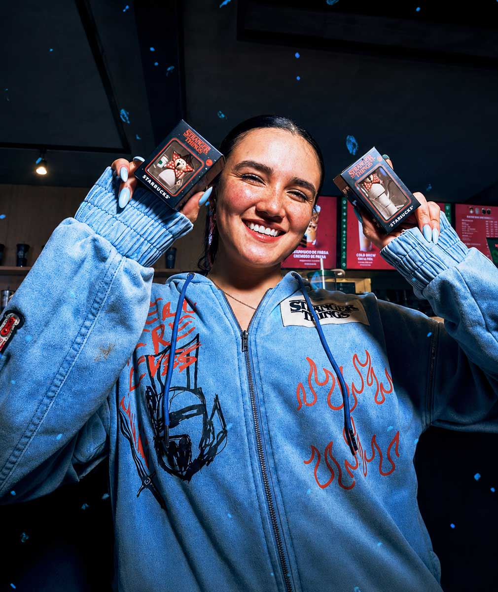 Guest posing with Stranger Things merchandise boxes