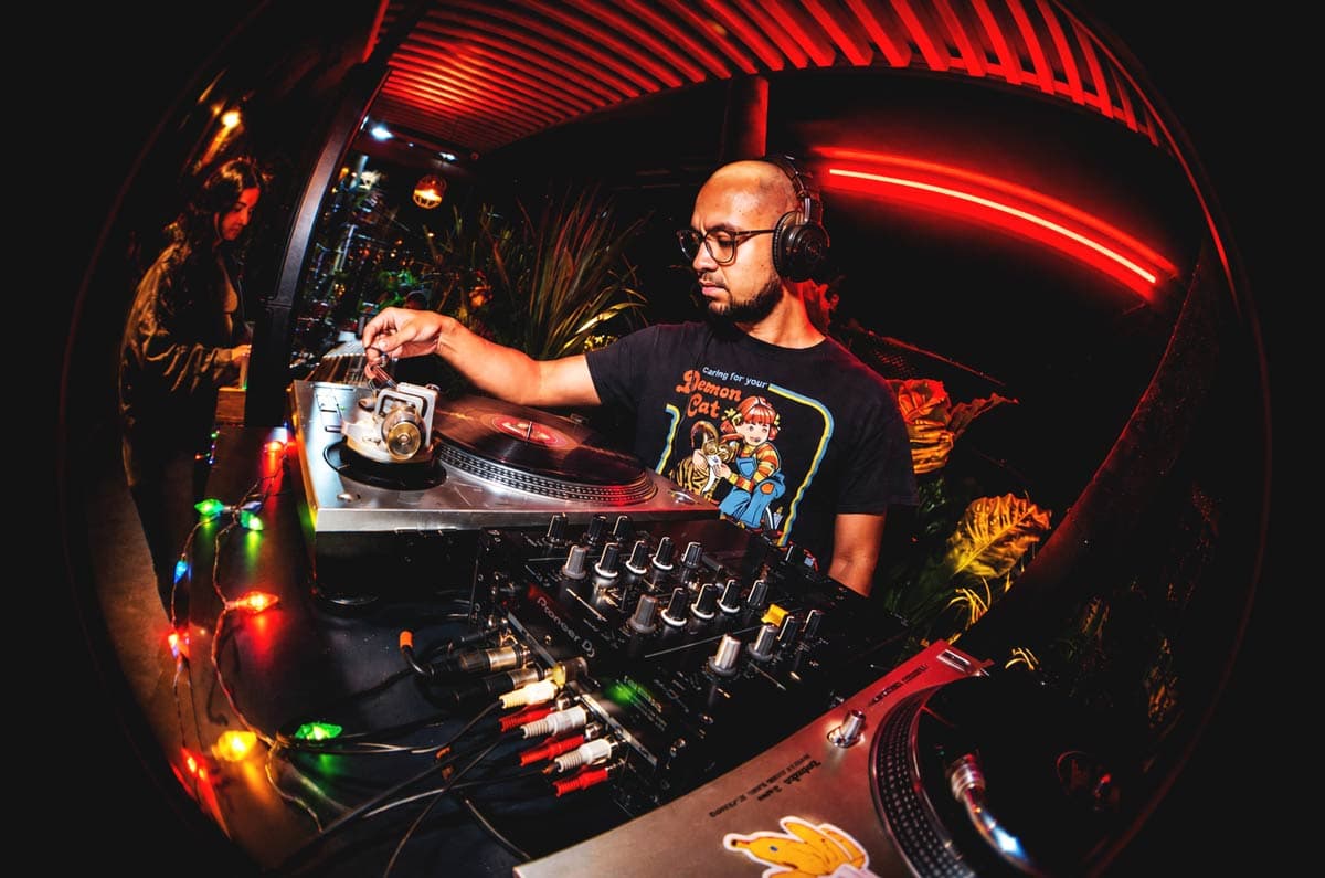 DJ performing in red illuminated setup