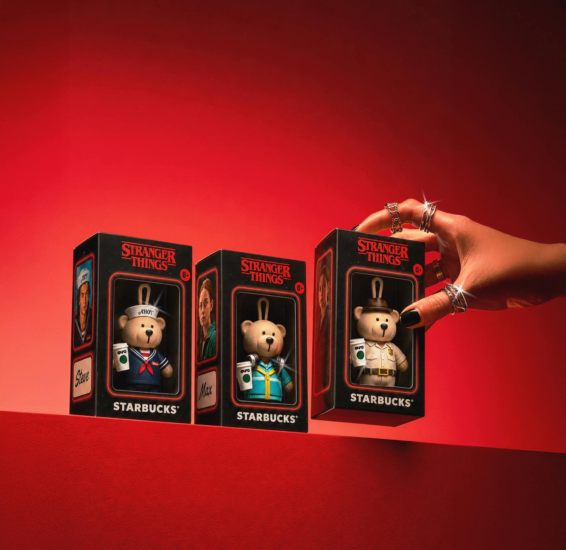 Hand reaching for Stranger Things boxed Bearista keychain figures