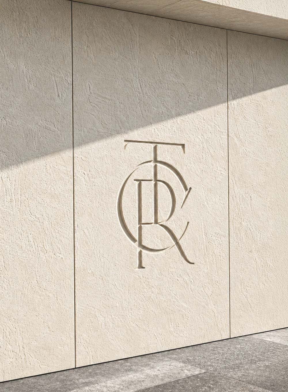 Engraved TC monogram in natural travertine stone